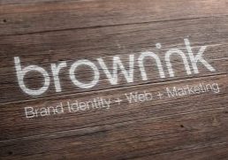 brown-ink-logo-white-paint-on-timber